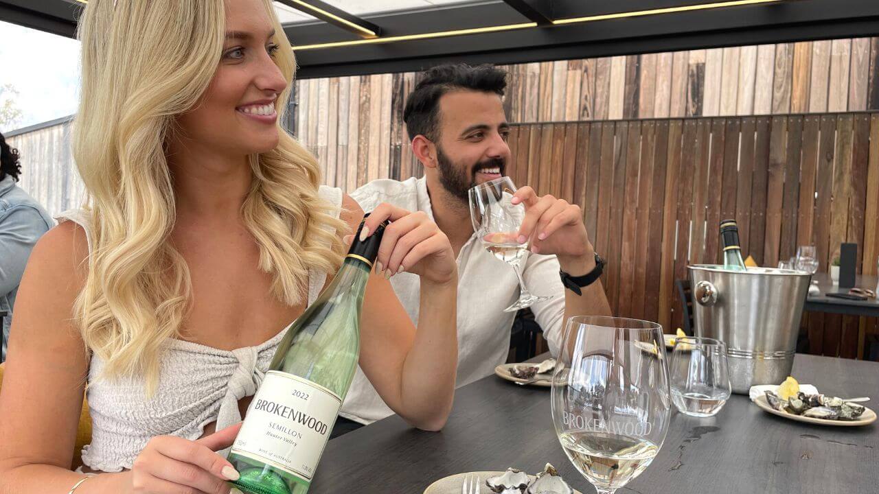Two smiling people enjoying Brokenwood Semillon at Terrace Wine Bar