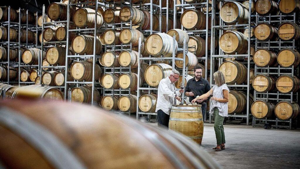 Guests tasting wine in the Brokenwood barrel room