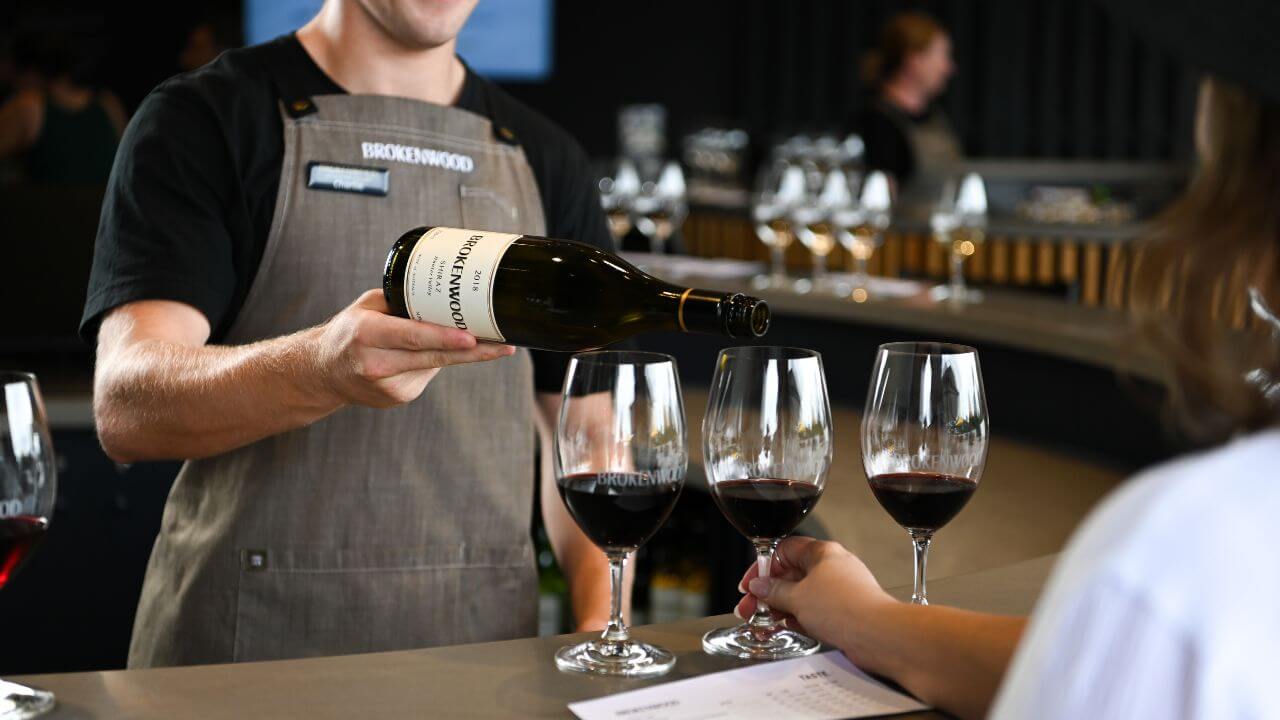 Brokenwood Wines Cellar Door team member serving wine