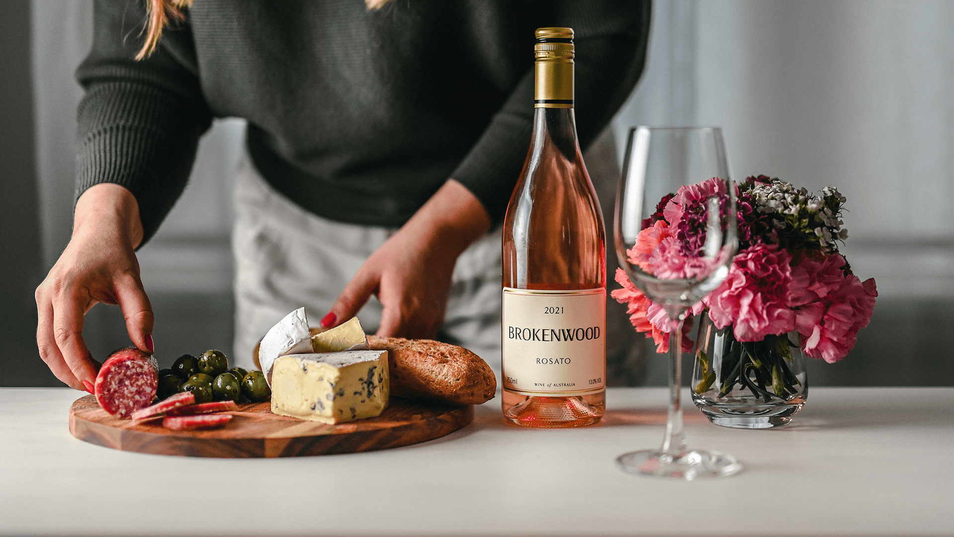 arranging-cheese-board-with-brokenwood-rosato-bottle