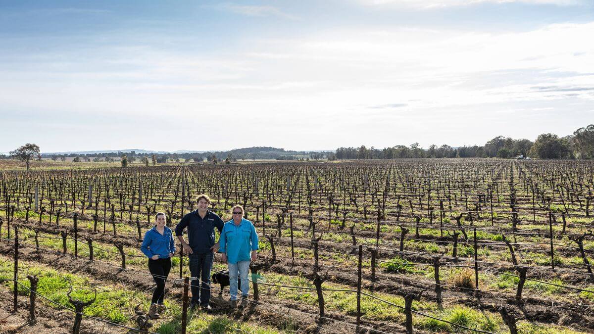 female winemakers Kate Sturgess and Kat Barry with Stu Hordern in vineyard